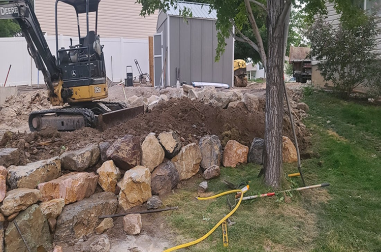Excavation and boulder wall construction for walkout basement