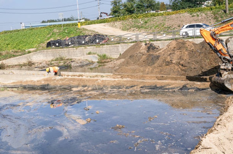 Construction workers working on the retention pond construction site